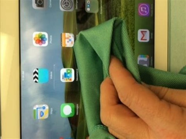 Can I use a damp cloth to clean my iPad screen?