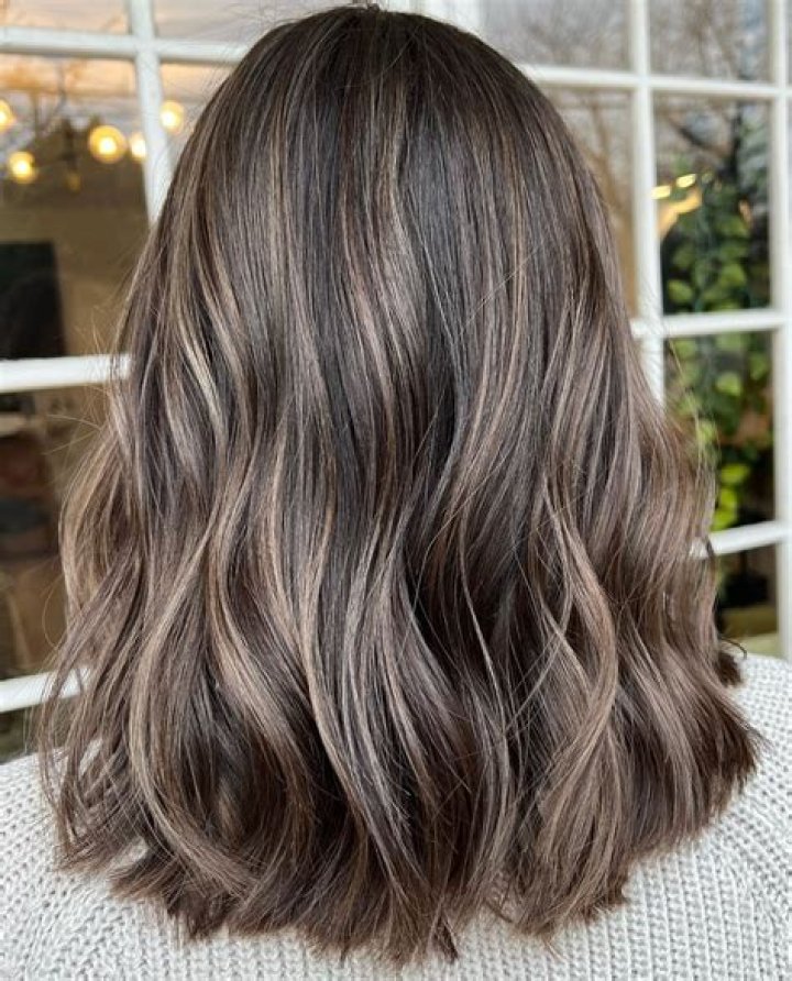 Can I use light ash brown on dark brown hair?