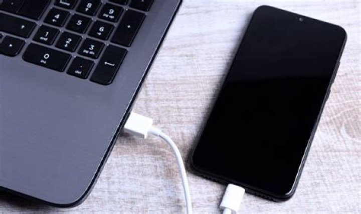 How do I connect my laptop to my PC with a USB cable?