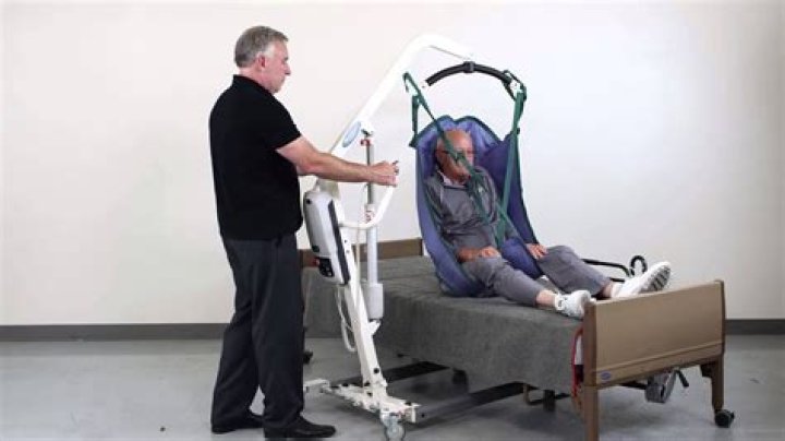 How do you lift a disabled person from bed?