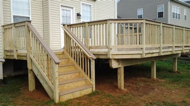 Should a deck railing be attached to the house?