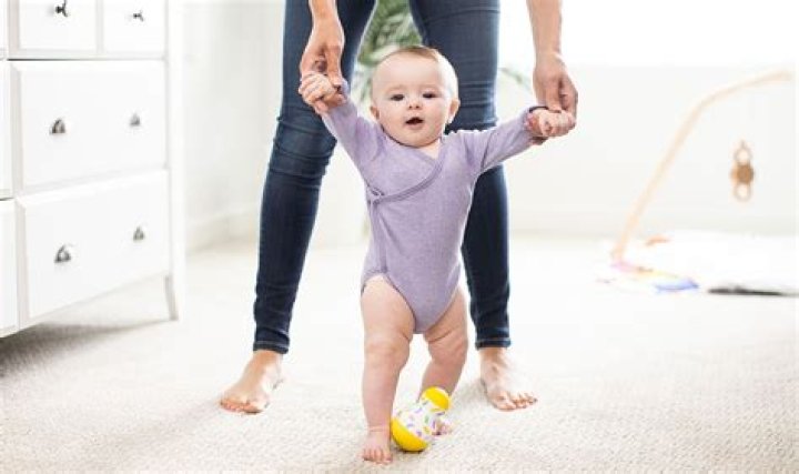 What age do babies walk along furniture?
