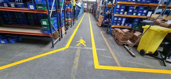 What do the yellow lines on the shop floor indicate?