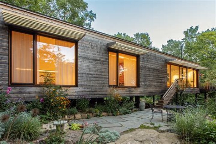 What does the Aboriginal proverb touch the earth lightly mean when it comes to designing and building a house?