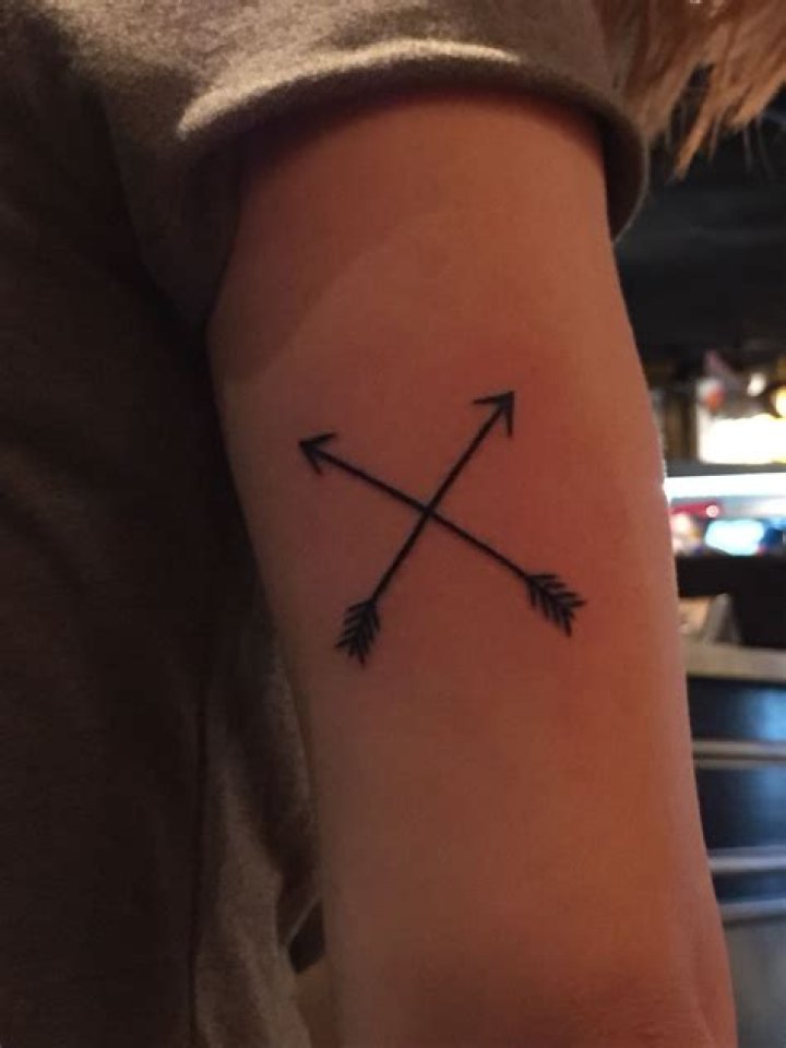 What does the crossed arrows tattoo mean?