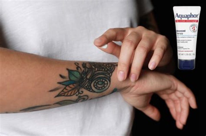 When should I stop using Aquaphor on my tattoo?