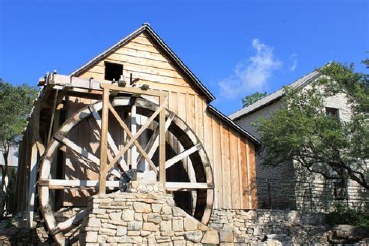 Who had to make an economic choice to pay to use a grist mill?