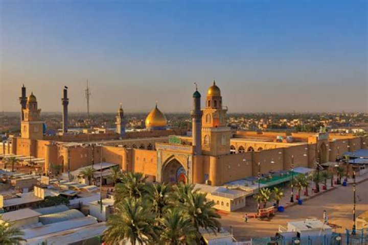 Who is buried in Masjid Kufa?