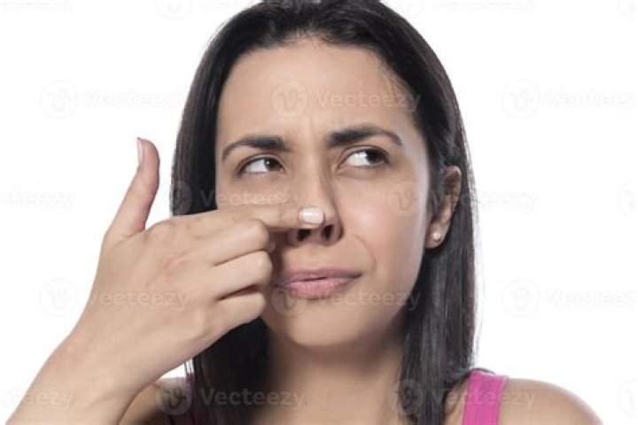 Why does Laura touch her nose?